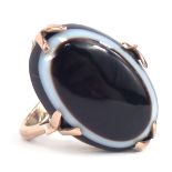 A 9ct gold bullseye agate dress ring, the oval bullseye agate in four double claw setting, on a rais