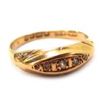 An 18ct gold diamond gypsy ring, the panel set with five tiny diamonds, with scroll design shoulders