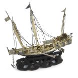 A white metal model of a ship, on an ebonised base, unmarked, 12cm high, 2.75oz gross, in fitted cas