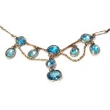 A 1920s blue paste stone set part necklace, the central swag drops 5cm wide, on elongated link chain