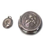 Two lockets, comprising a silver horseshoe applied locket, 2.5cm high, and a religious scene locket