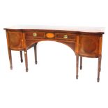 A Titchmarsh and Goodwin Sheraton Revival mahogany and inlaid serpentine fronted sideboard, the shap