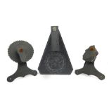 Three slate dials, each with spin top, on a slate backing frame, one marked Wales, the tallest 17cm