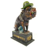 A reproduction Nicholls Cigar Old Puffer money box, formed as a dog, 21cm high.