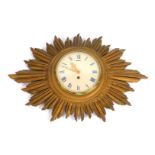 A 19thC star burst clock, the cream metal Roman numeric dial with thirty hour movement, span outer f
