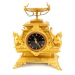 A 19thC French ormolu mantel clock, urn finial, with swan and lion mask swag handles, and a black en