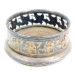 A small late Victorian silver plated circular coaster, with pierced fruiting vine decoration to the