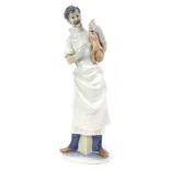 A Lladro porcelain figure modelled as an obstetrician, printed marks, 35.5cm high.