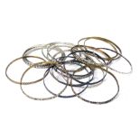 A group of hammered design bangles, brass and white metal. (a quantity)