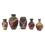 Five Pat Armstrong Studio Pottery vases, on a blackened rainbow mottled ground, the largest 23cm hig