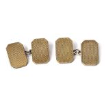 A pair of cufflinks, rectangular form with engine turned cross hatching, marked 9ct gold on sil, 7g