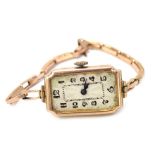A 9ct gold cased wristwatch, with a rectangular white enamel face, and fifteen jewel movement, on ex