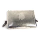 A George V silver coin purse, the outer case with engine turned decorated and vacant circle cartouch