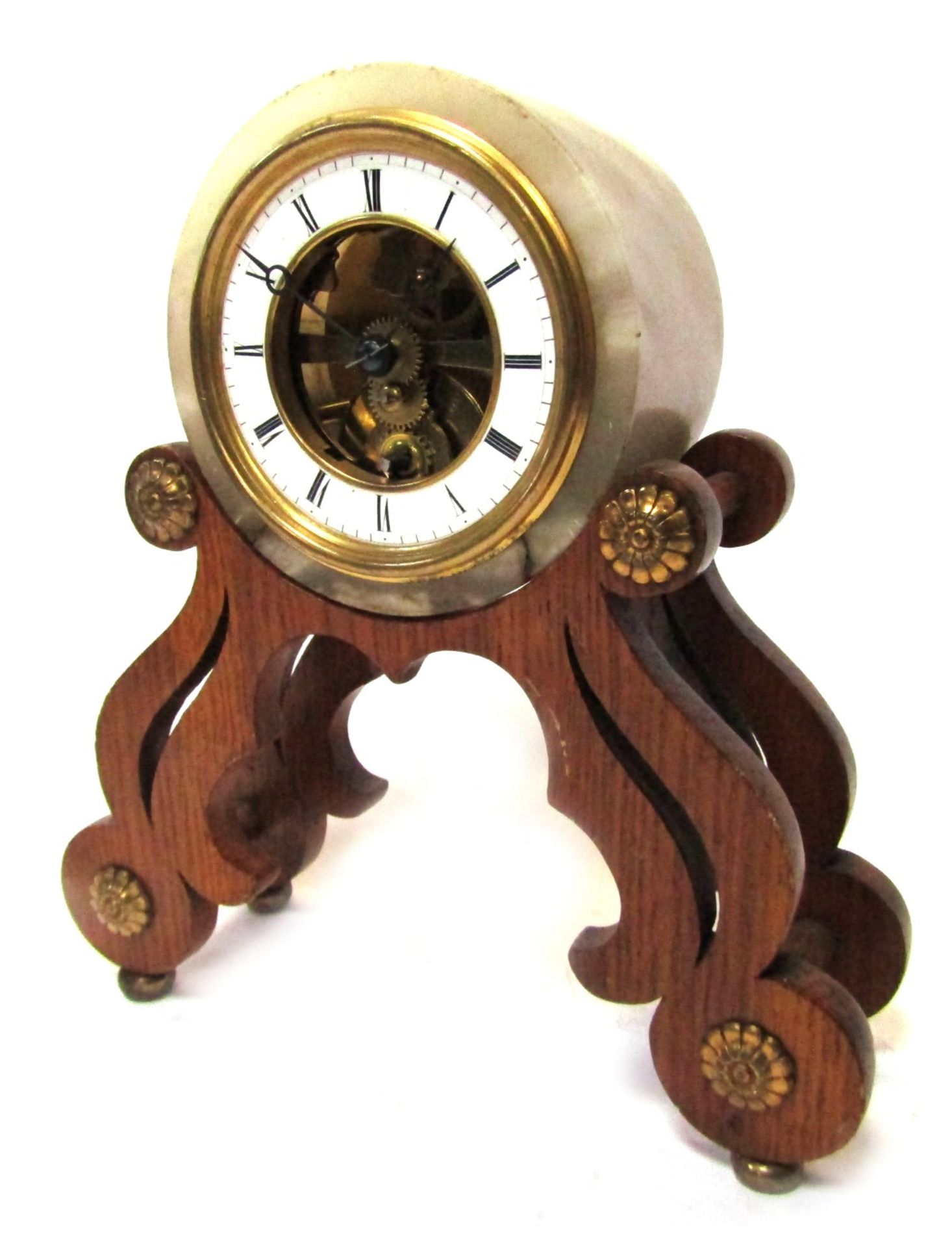 A French mantel clock, with a circular white onyx frame, with central open work skeleton movement, w