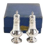 A pair of George V silver pepper pots, of plain design, maker JBC, Birmingham 1925, in fitted case,