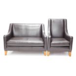 A Multi York black leather sofa suite, comprising two seater sofa and armchair bearing label.