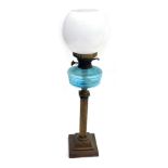 A Victorian oil lamp, on brass stem with blue reservoir, and opaque white shade, 67cm high.