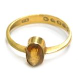 A 22ct gold dress ring, converted from a wedding band with central citrine, in rub over setting, rin