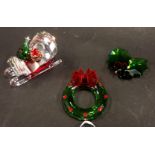Three Swarovski crystal Christmas ornaments, comprising sleigh 5cm wide, holly wreath 5cm high, and