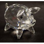 A Swarovski crystal pig, 6cm wide, boxed.