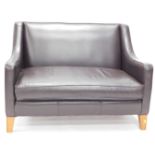 A Multi York black leather two seater sofa.