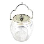 A cut glass biscuit barrel, with silver plated mount and loop handle, a set of ebonised metal and br