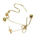 A pair of yellow metal drop earrings, unmarked, and a single ball drop earring, unmarked, 2.6g all i