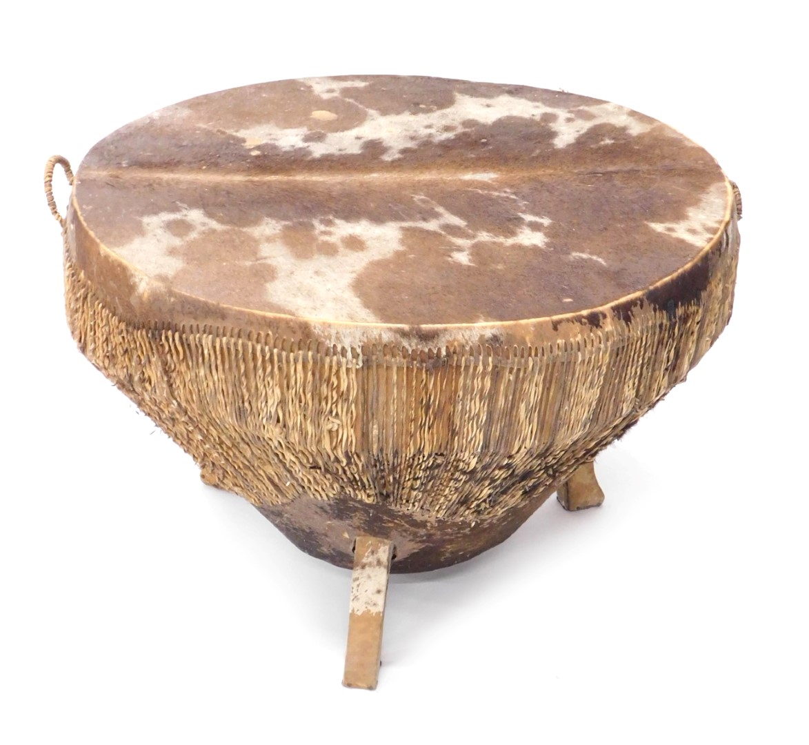 A tribal drum, with hide top, on pine base, 50cm high, 75cm diameter.