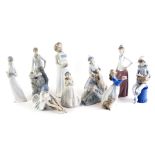 A collection of Nao porcelain figurines, to include girl with a dog, a young child dressed as a Harl