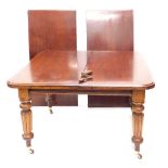 A 19thC mahogany extending wind out dining table, with two leaves, on turned reeded legs terminating