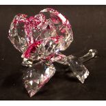 A Swarovski crystal rose, with pink tinted design, 8cm wide, boxed.