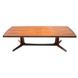 A mid to late 20thC Danish rosewood coffee table, the rectangular top with rounded ends, on trestle
