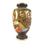 A Japanese earthenware vase, decorated with male and female figures, etc., within tube lined borders