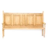 A stripped pine bench, with panelled back, flanked seat and turned legs, 124cm high, 90cm wide, 48cm