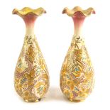 A pair of Doulton Slaters Patent type bottle shaped vases, each decorated with flowers and leaves, i