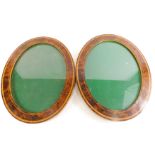 A pair of yew and tulipwood cross banded oval frames, 37cm x 47cm.
