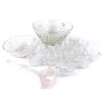 A pressed glass punch bowl, plastic ladle, and various hanging cups.