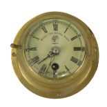 A brass cased ship's clock or timepiece, stamped to the dial Made For Royal Navy, London, 13cm diame