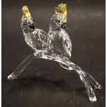 A Swarovski crystal figure group of two parakeets on perch, 10cm wide.