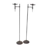 A pair of wrought iron candle stands, each of pricket form, 96cm high