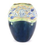 A Royal Doulton stoneware vase, with sgraffito decoration of flowers and leaves, in blue within gree