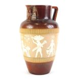 A Doulton Lambeth stoneware jug, decorated with a band of Egyptian figures, with angular handle and