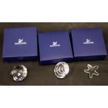 Three Swarovski crystal sea figures, comprising clam, starfish and conch shell, 4cm wide, boxed. (3)