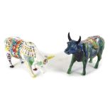 A Cow Parade ceramic figure of a cow, decorated with multi coloured design, and another similar. (2)