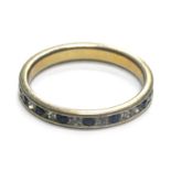 A 9ct gold and silver eternity ring, set with blue and white paste stones, some missing, ring size P