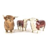 Three Beswick cows and bulls, comprising a CH champion Hereford bull and cow, and a highland bull, 1