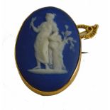 A 9ct gold framed Wedgwood blue Jasperware brooch, of semi clad female with Neoclassical flowers, in