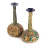 A matched pair of Royal Doulton Slaters Patent bottle shaped vases, each decorated in gold, turquois