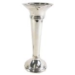 A George V silver stem vase, with a fluted rim and a three ringed collar, on a stepped foot with wei