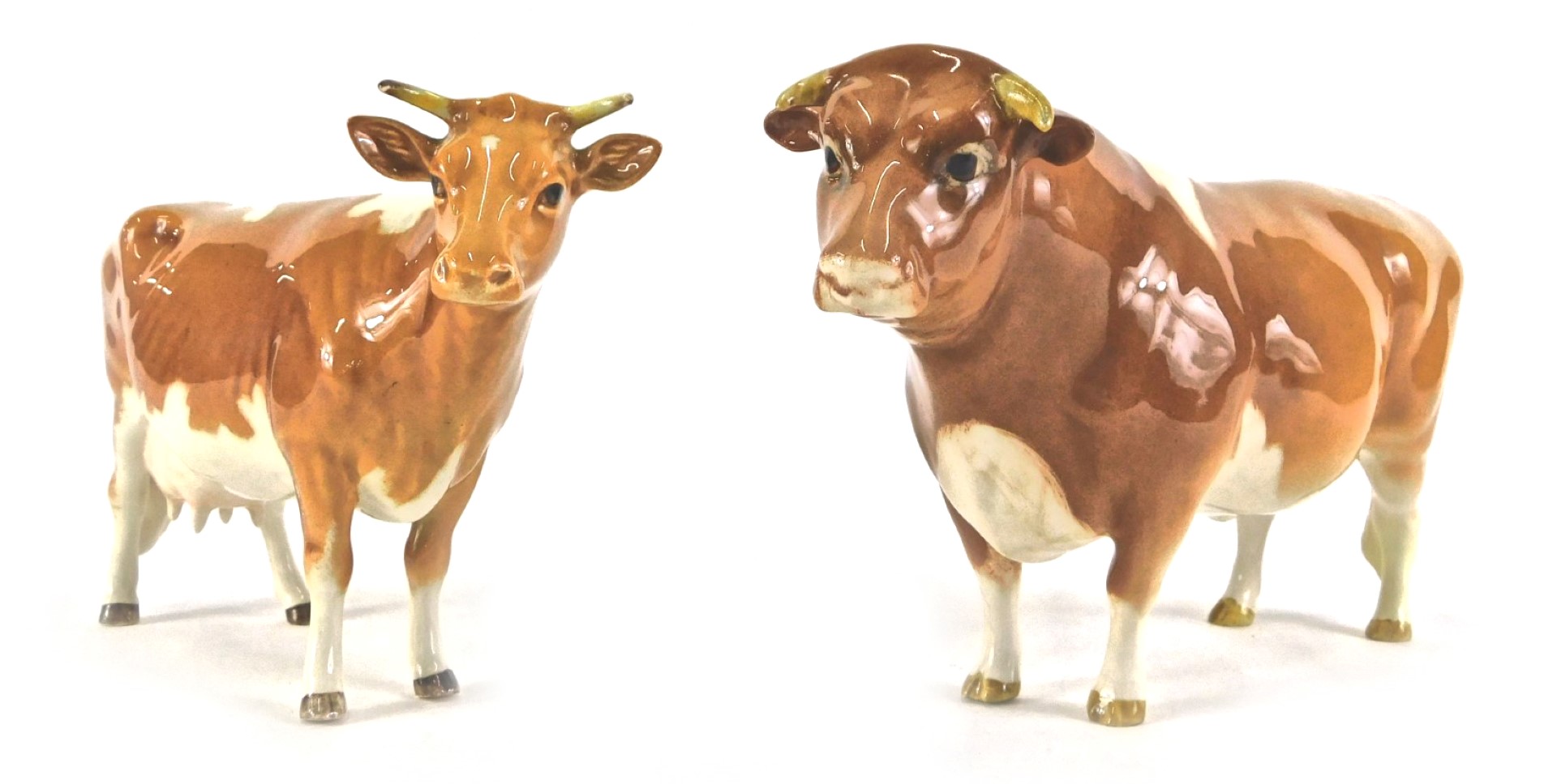 Two Beswick cattle, comprising a CH Sabrina's Sir Richmond 14th Guernsey bull and a cow, 11cm high.